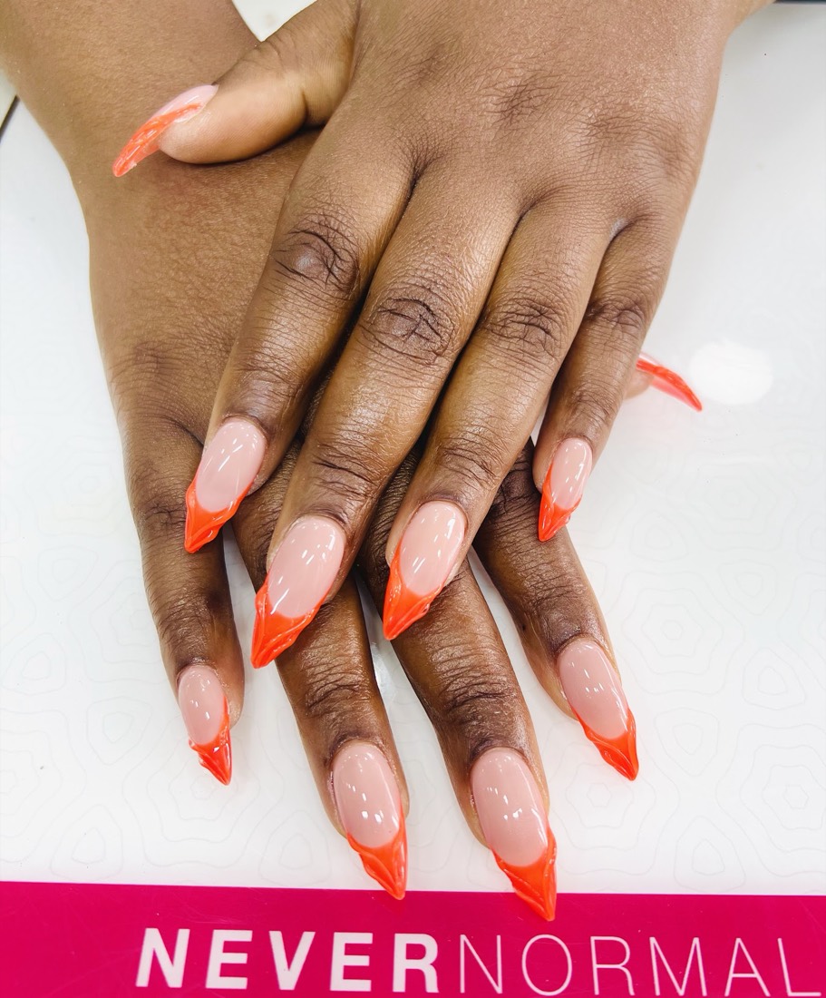 Long stiletto nails with bright orange French tips