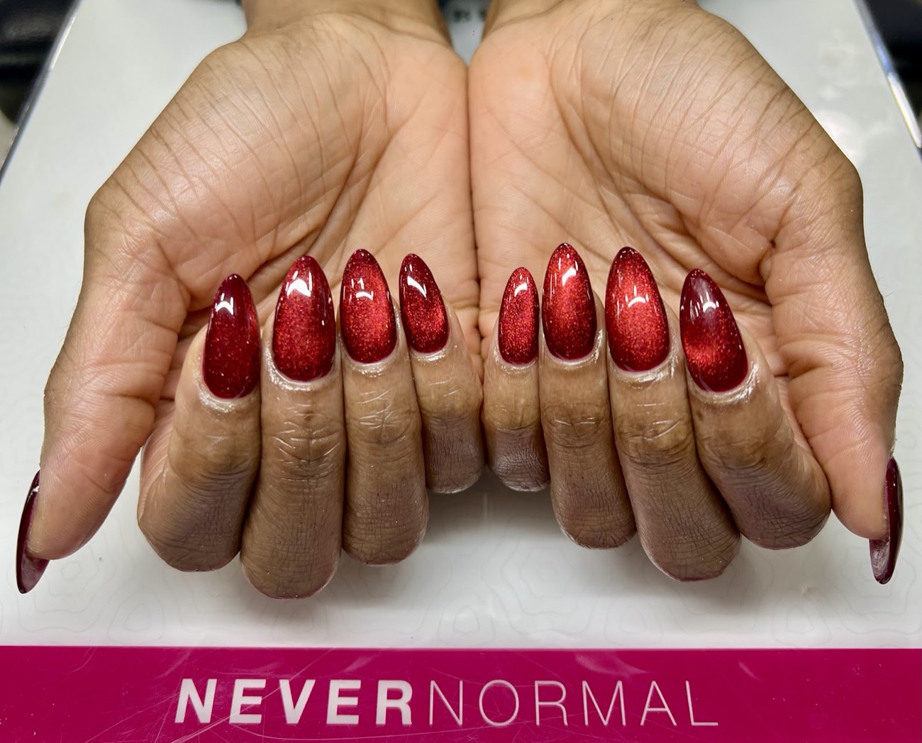 Deep red glitter cat-eye almond nails